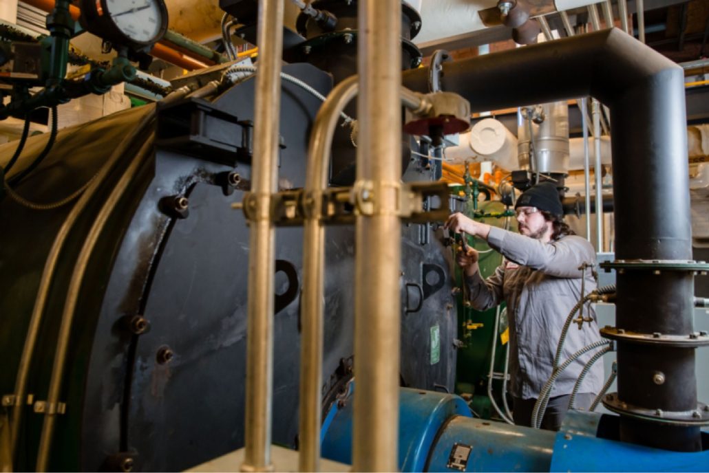Service tech working on a commercial boiler